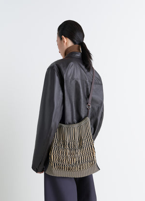 Lemaire Large Crossbody Filt Net Ba in Nylon Mesh and Leather, model shot, Back view with shoulder strap Porte over shoulder