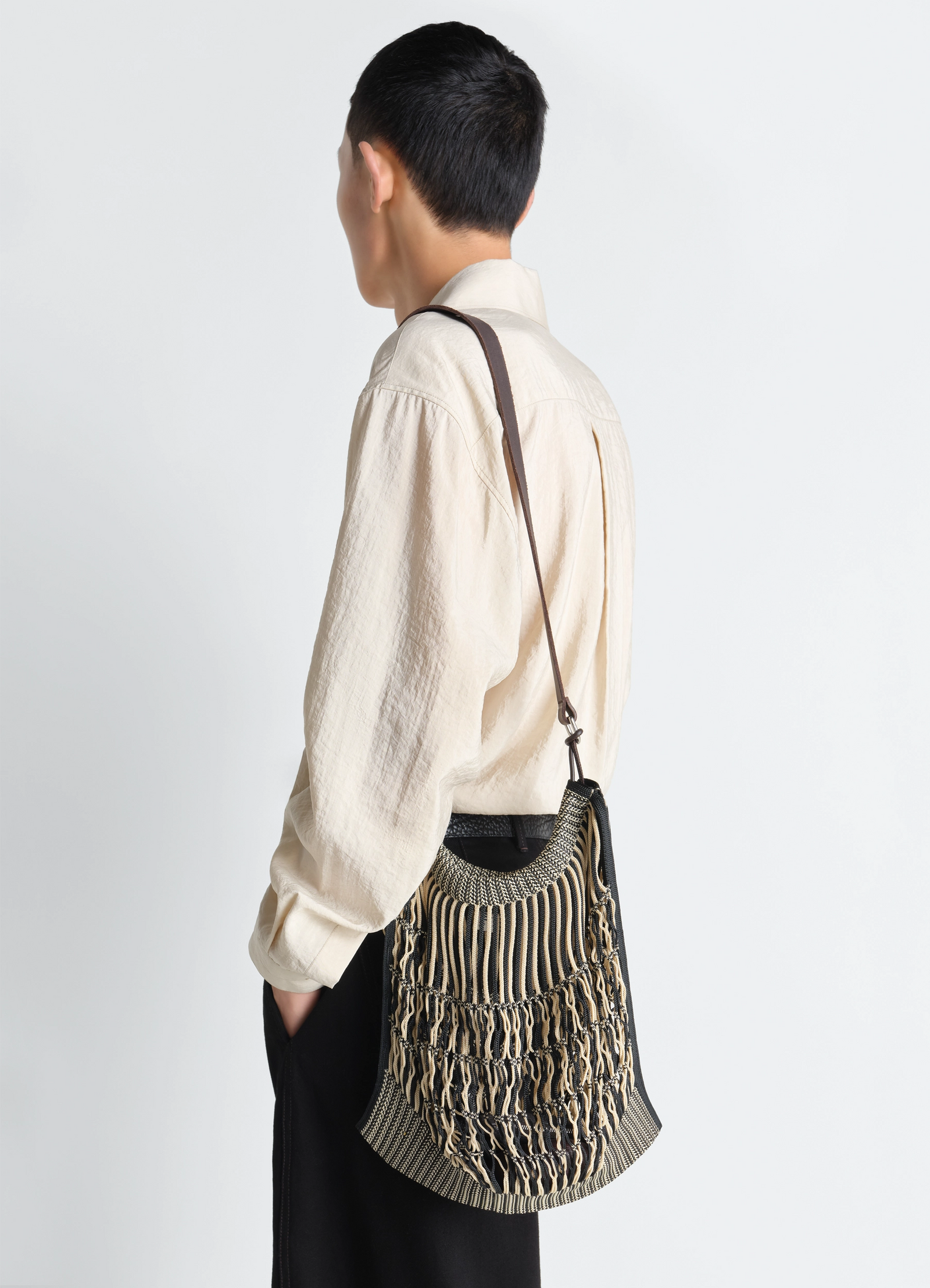 Lemaire large crossbody filt net sh in nylon mesh and vegetable-tanned lea, model shot, back view woven stripe pattern