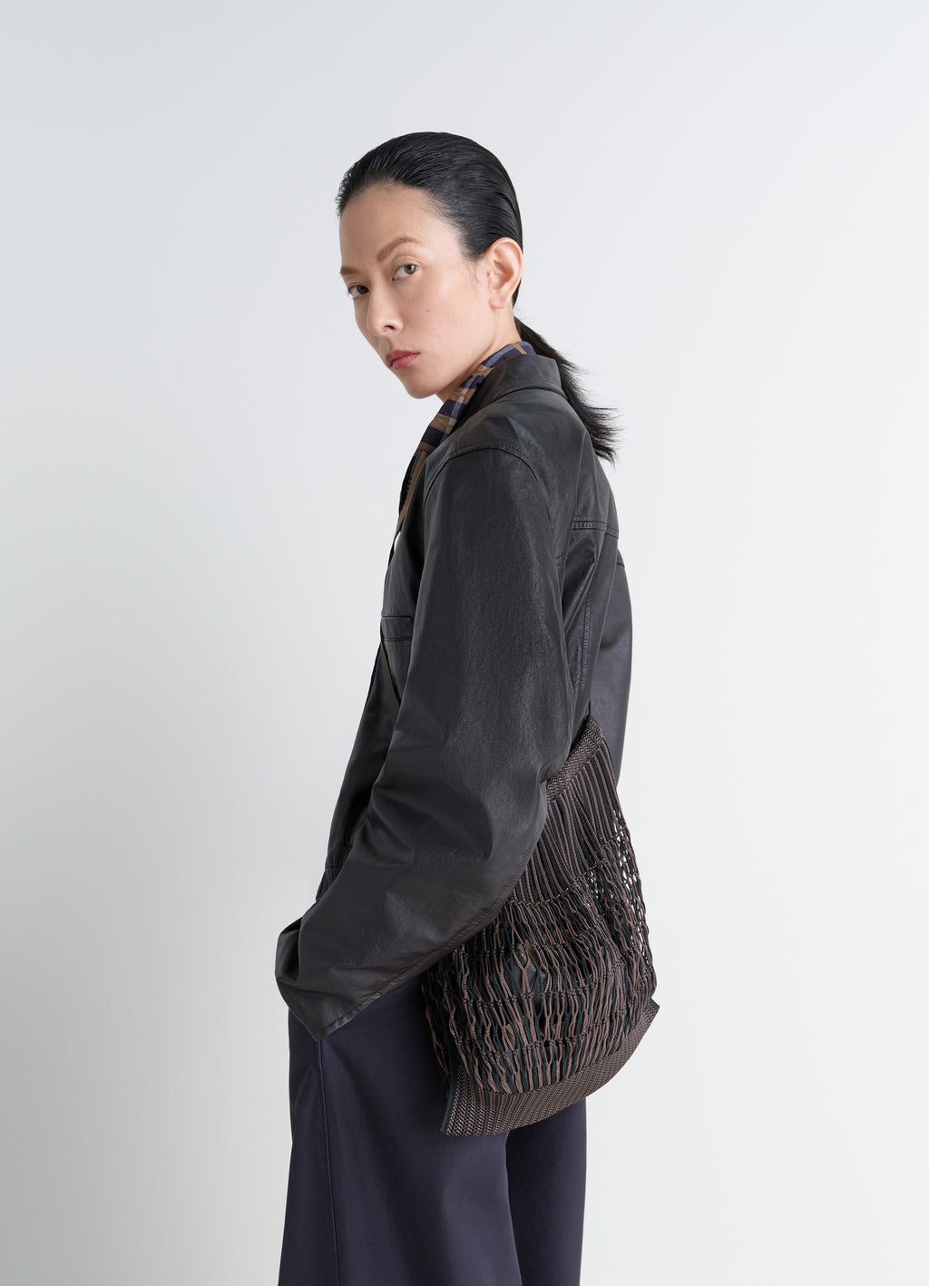 Lemaire Large Crossbody Filt Net Sh in Nylon mesh, vegetable-tanned leathe, model shot, side view worn slouched casual style