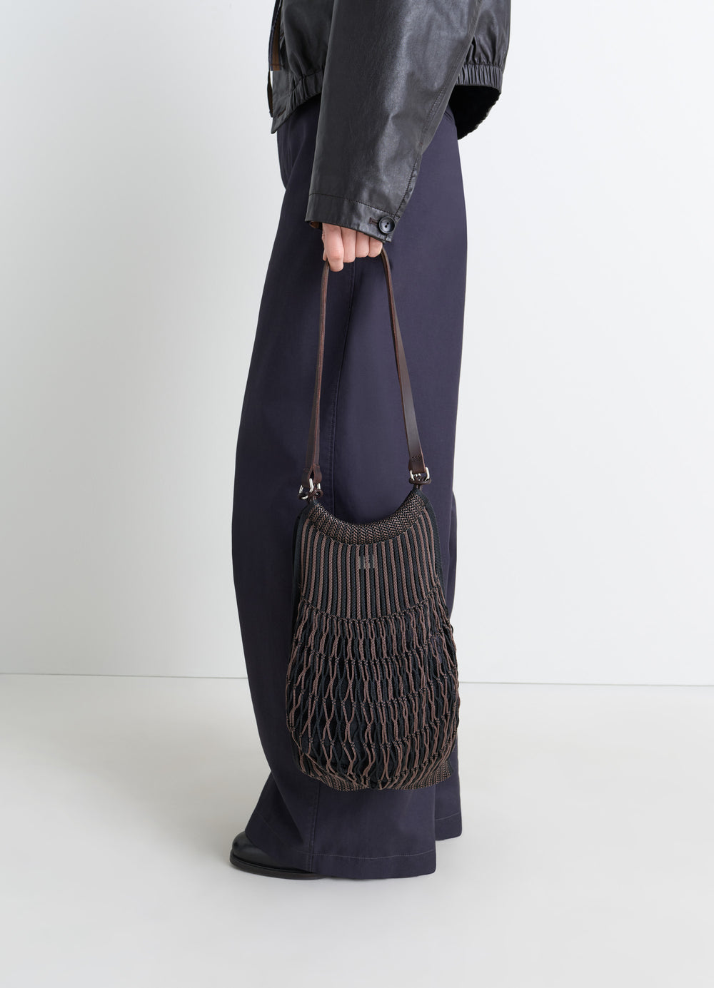 Lemaire Filt Net Shopping Bag in Nylon mesh, leather, model shot, handheld side detail textured knit netting