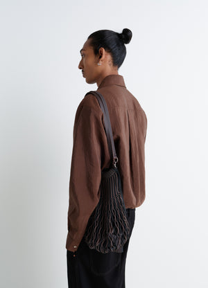 Lemaire Filt Net Shopping Bag in Nylon mesh, leather, model shot, Side view Shoulder strap detail