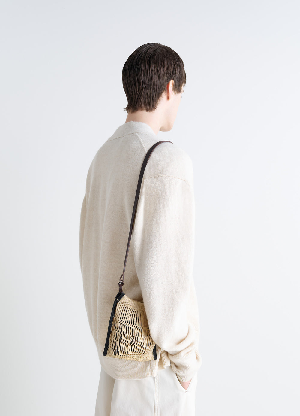 Lemaire x Filt Mini Crossbody in Nylon Mesh, Vegetable-tanned Leathe, model shot, Back view Minimalist with leather strap