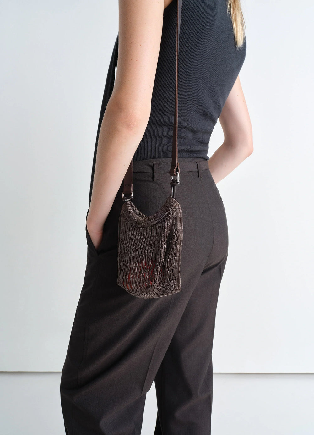 Lemaire Mini Crossbody Filt Net Bag in Dark Chocolate Nylon and Leather, model shot, Side view Worn cross-body on model