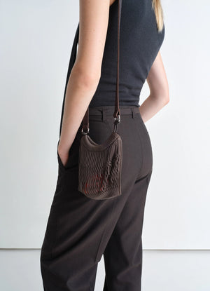 Lemaire Mini Crossbody Filt Net Bag in Dark Chocolate Nylon and Leather, model shot, Side view Worn cross-body on model