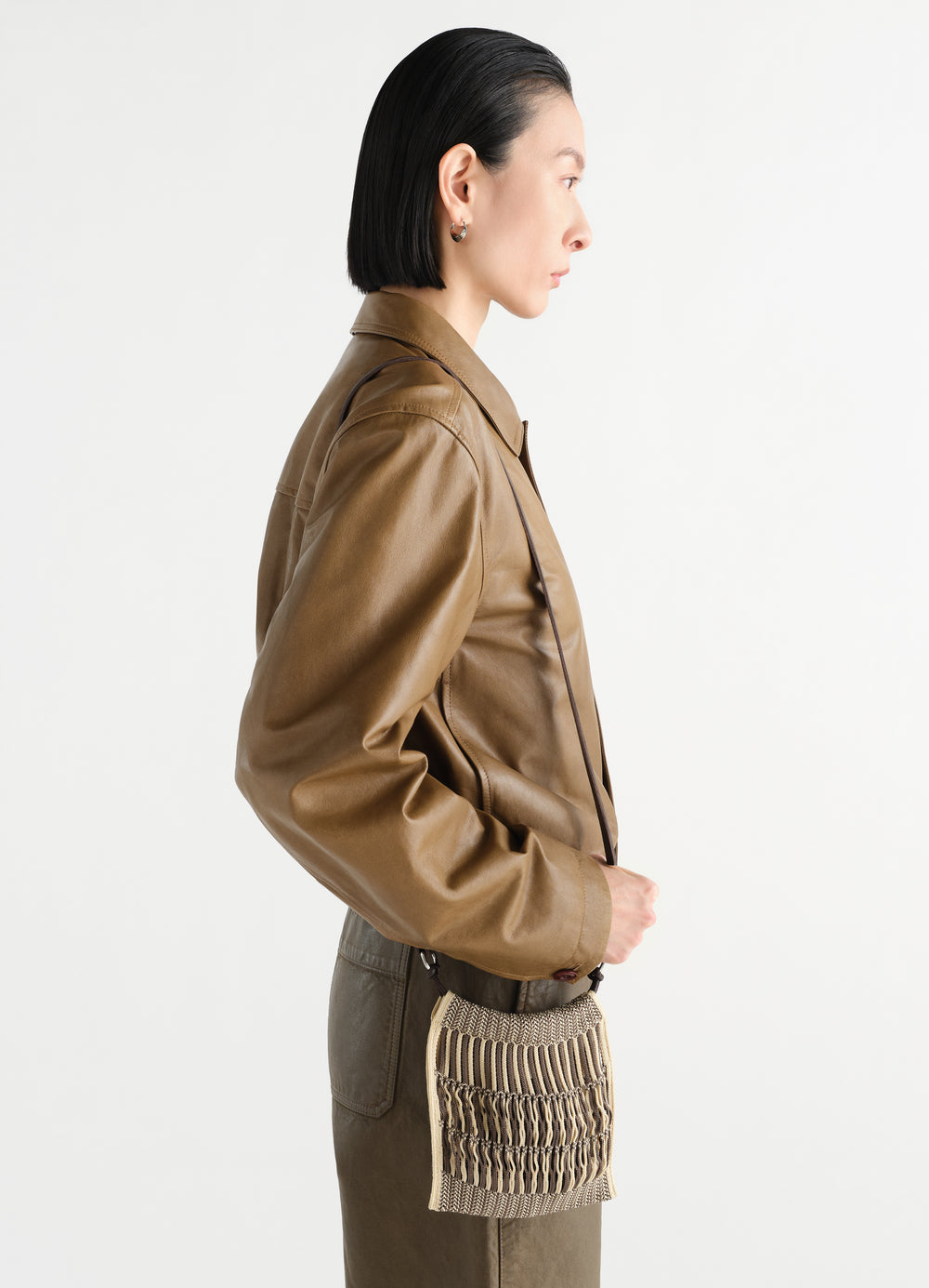 Mini crossbody filt net bag by LEMAIRE in beige cotton worn by model side view