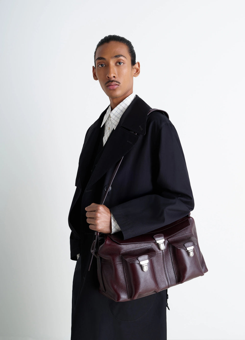 Lemaire Week-End Gear Bag in Glossy Vegetable-Tanned Leather, model shot, Side view Adjustable shoulder strap