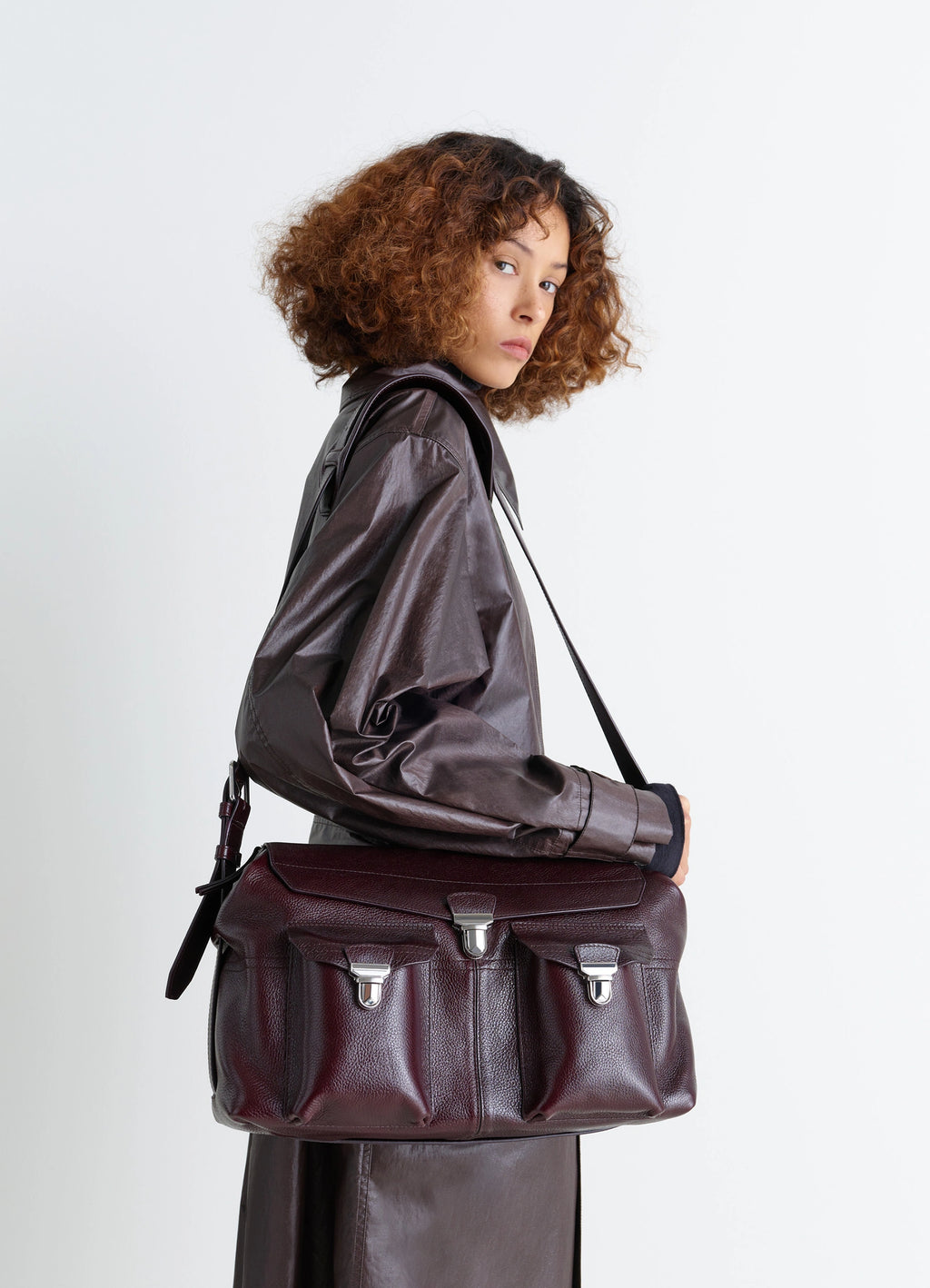 Lemaire Week-End Gear Bag in Glossy Vegetable-Tanned Leather, model shot, three-quarter back view secure buckle closures