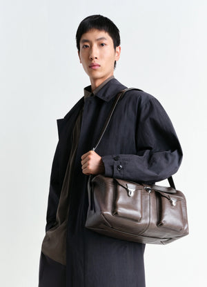 Week-end Gear Bag in Irregular Grained Leather, model shot, Side view Three front pockets