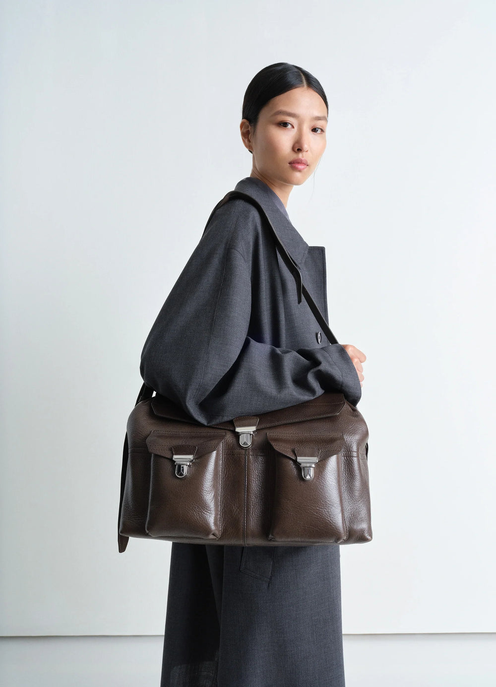 Week-end Gear Bag in Irregular Grained Leather, model shot, 3/4 view worn on shoulder