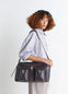 WEEK-END GEAR BAG in glossy vegetable-tanned leather, model shot, side view adjustable shoulder strap