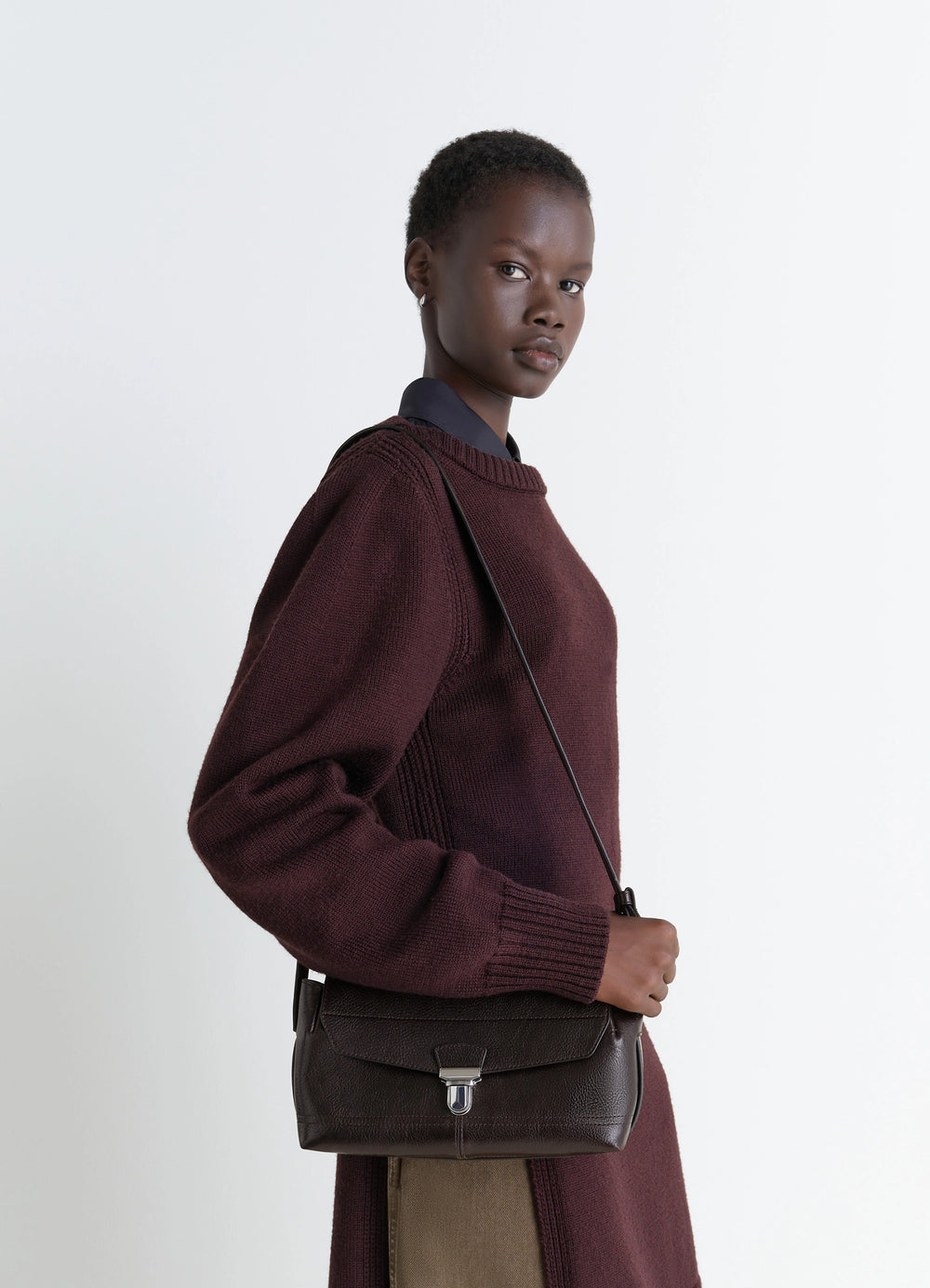 Lemaire Small Gear Bag in Glossy Vegetable-Tanned Leather, model shot, three-quarter view worn crossbody