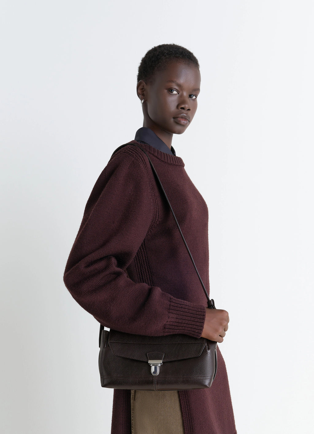 Lemaire Small Gear Bag in Glossy Vegetable-Tanned Leather, model shot, three-quarter view worn crossbody