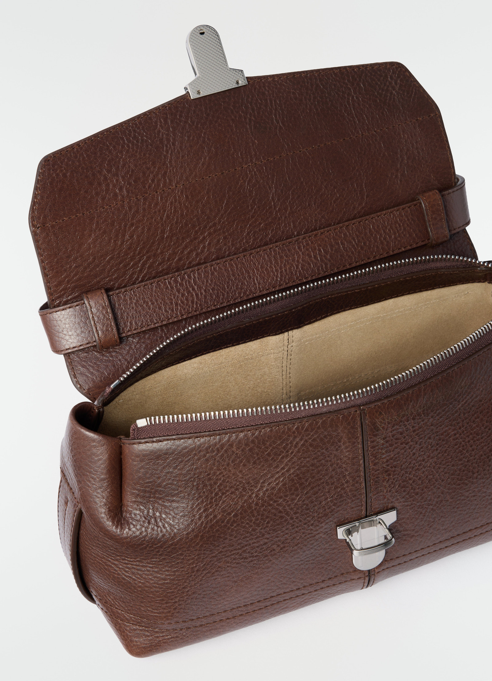Small brown leather gear bag by lemaire open showing beige interior close-up detail on white background