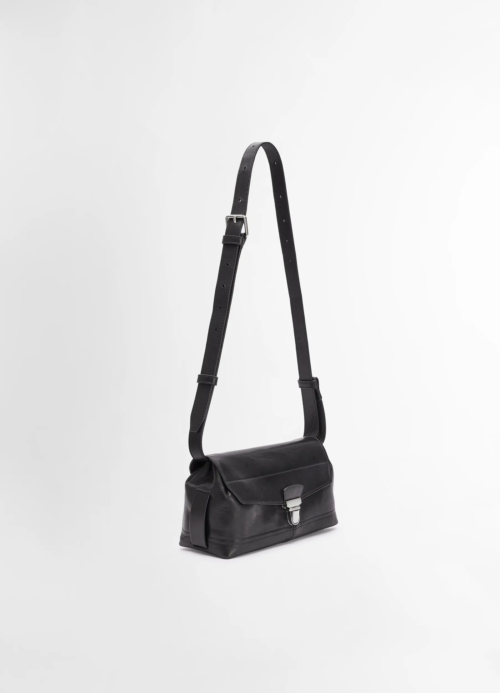 Lemaire small gear bag in black vegetable-tanned nappa leathe, product shot, angled view adjustable strap detail