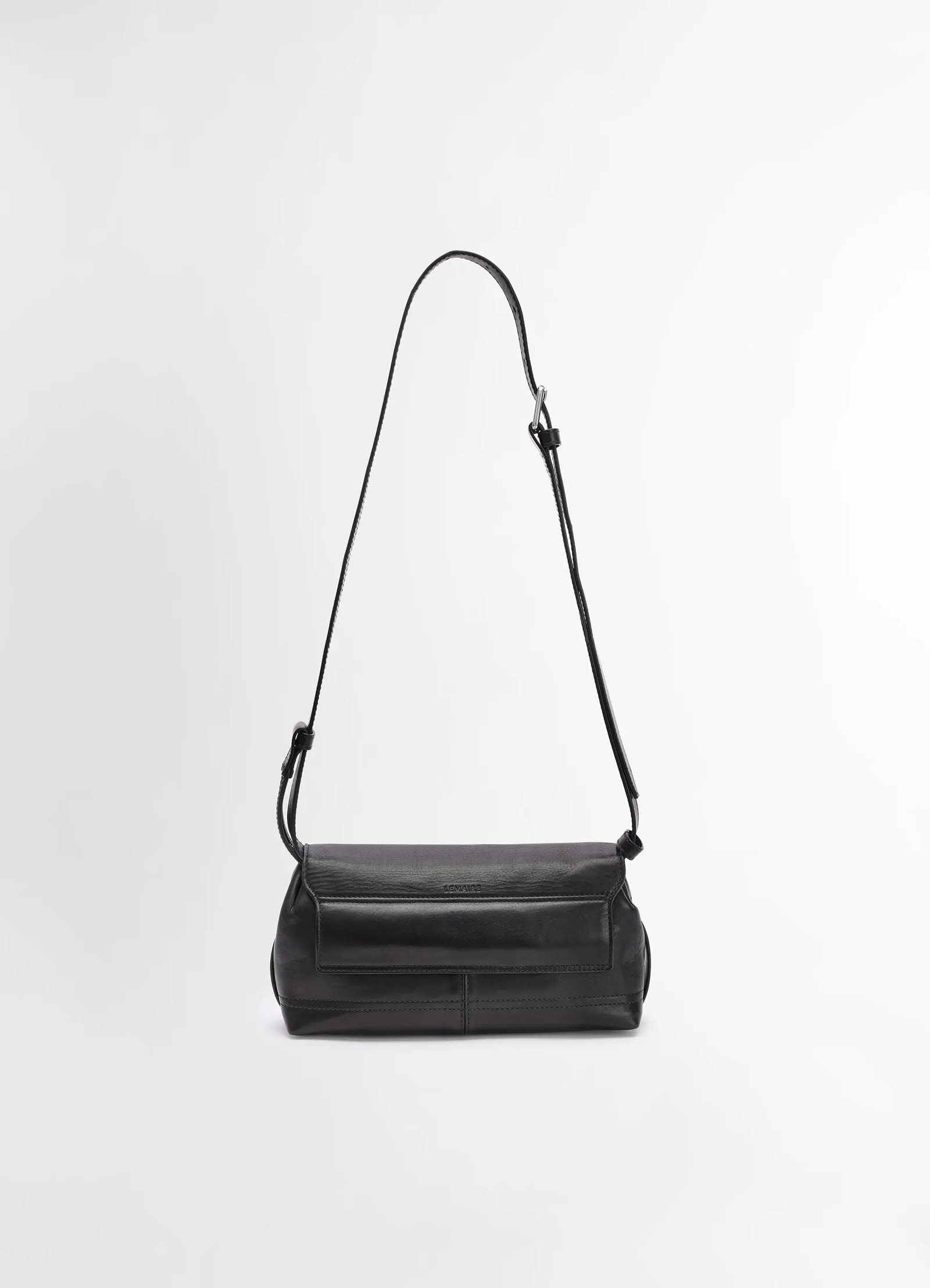 Lemaire small gear bag in black vegetable-tanned nappa leathe, product shot, back view minimalist flap detail