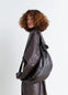 Lemaire Medium Soft Croissant in Paper-effect leather, model shot, Side view Curved with side pleats