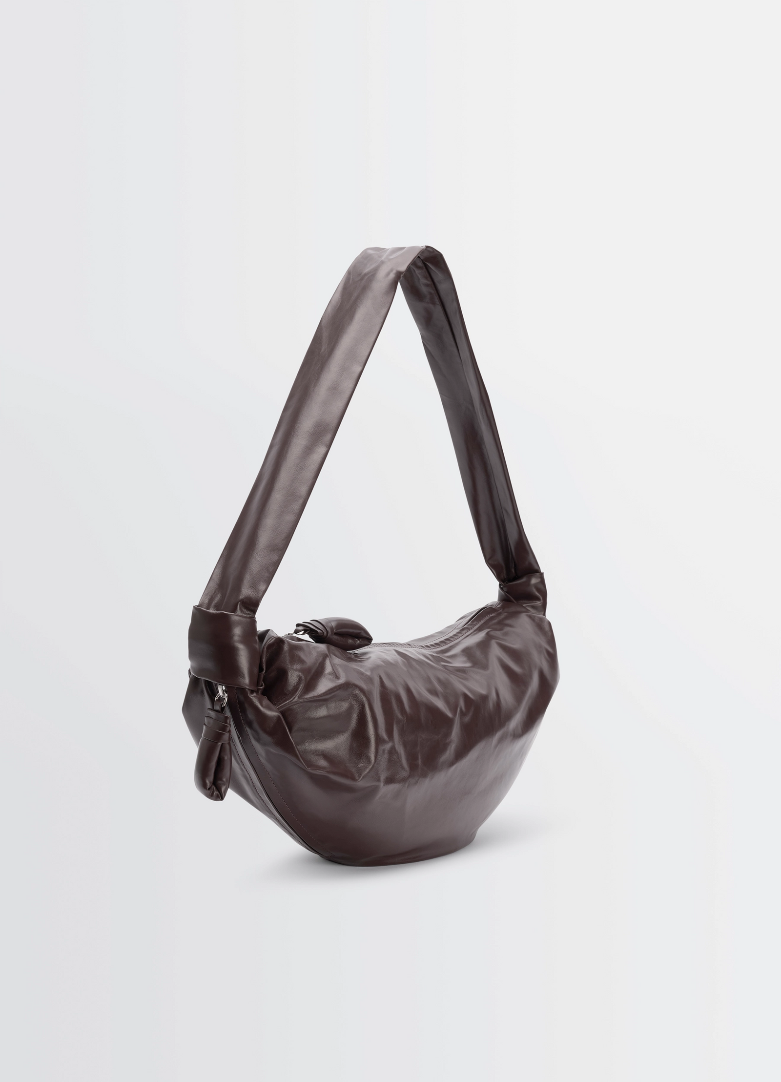 Medium soft croissant bag in paper leather, product shot, three-quarter back view oversized handle