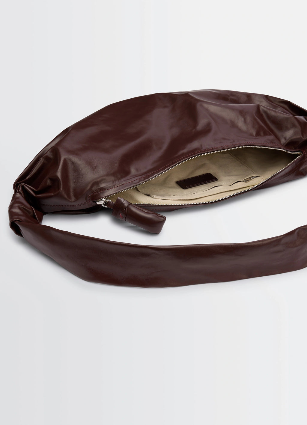 Lemaire Medium Soft Croissant in paper-effect leather, product shot, top view exposed zipper detail