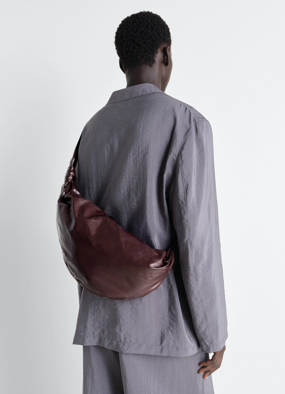 Medium Soft Croissant Bag in Paper Leather, model shot, back view shoulder drape