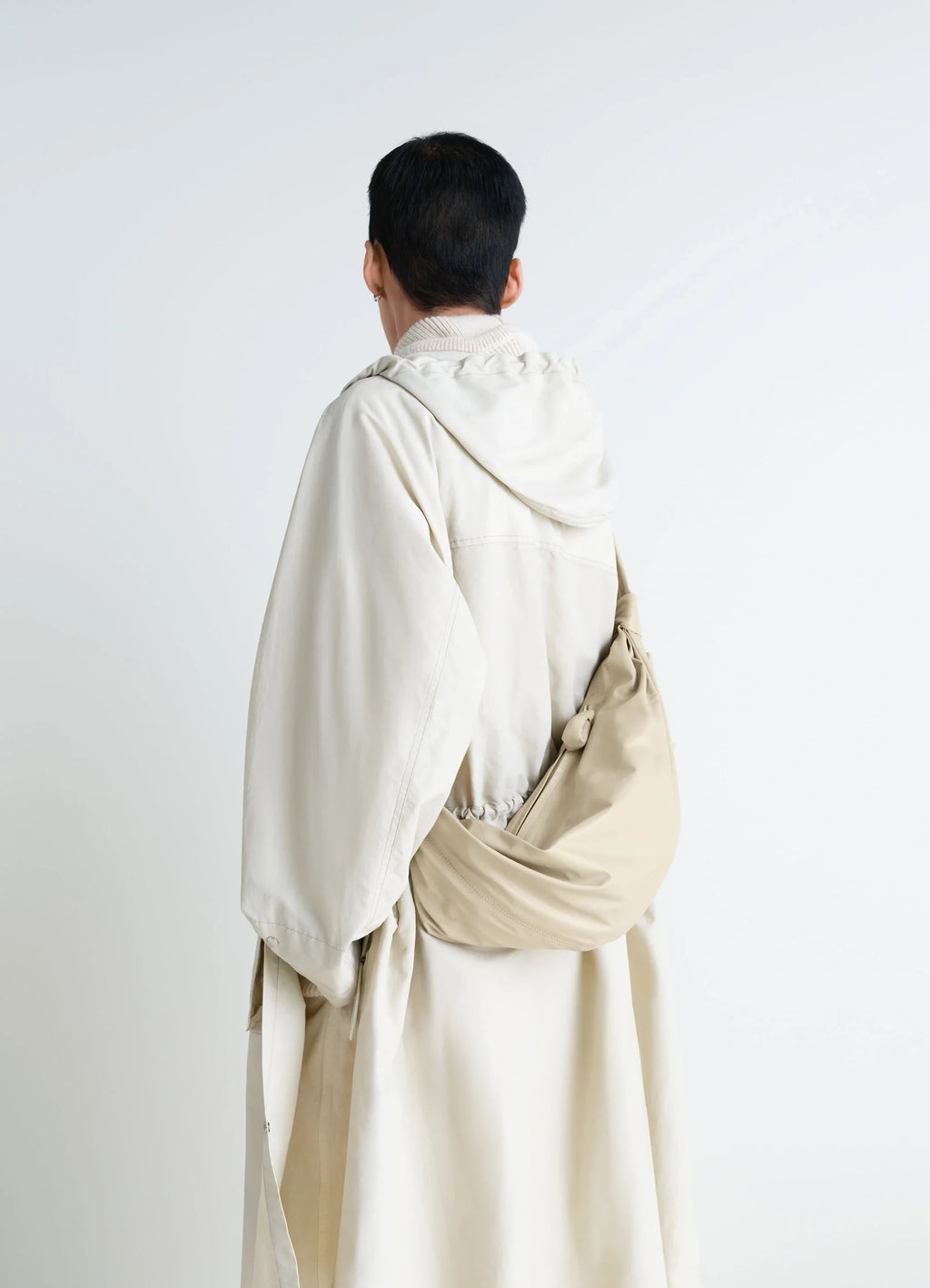 Lemaire Medium Soft Croissant in Paper-effect leather, model shot, over-the-shoulder view smooth texture, draped effect