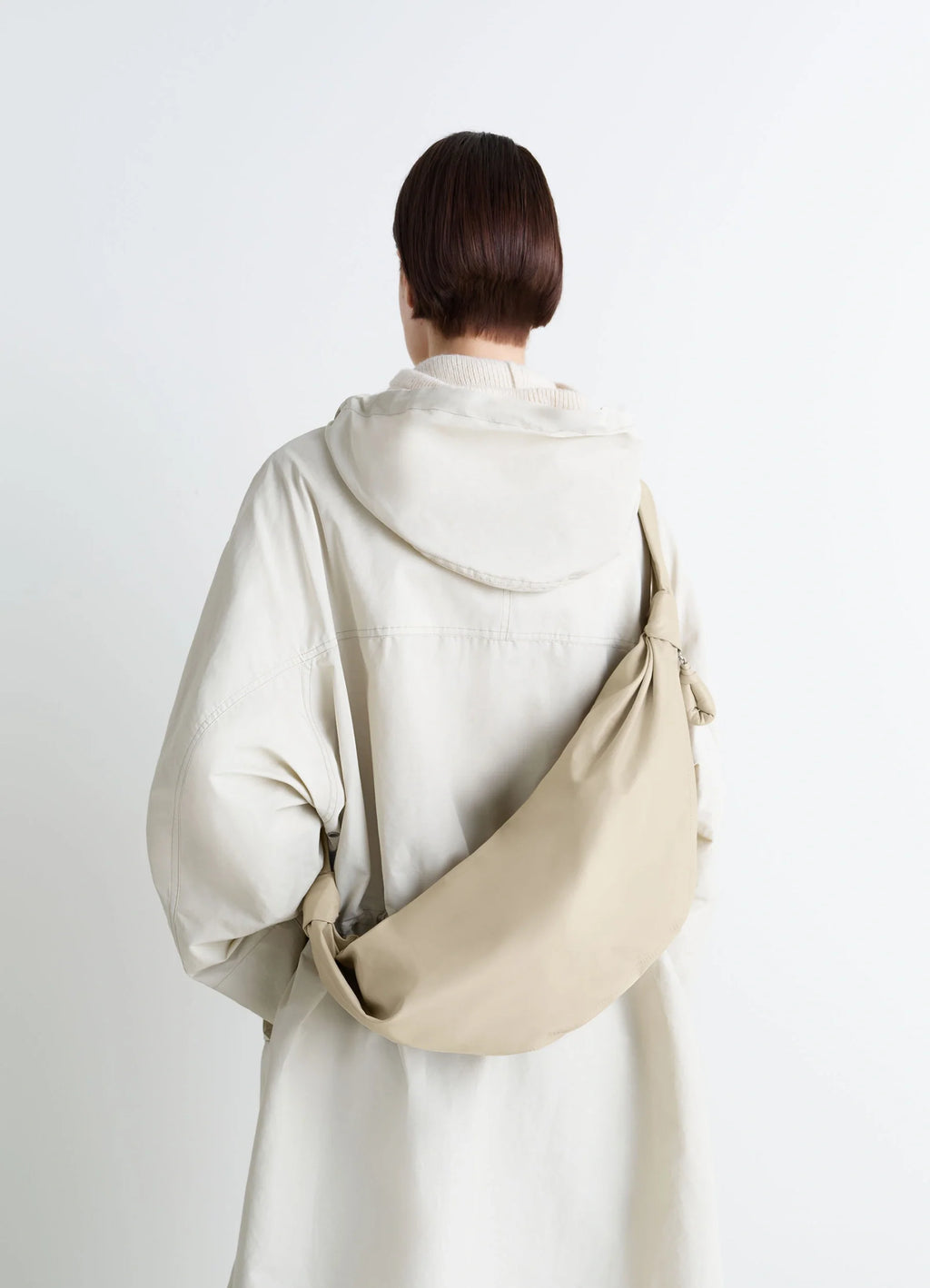 Lemaire Medium Soft Croissant in Paper-effect leather, model shot, Back view Knotted elements visible