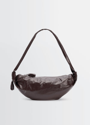 Medium soft croissant bag in dark brown paper leather lemaire front view on plain white background