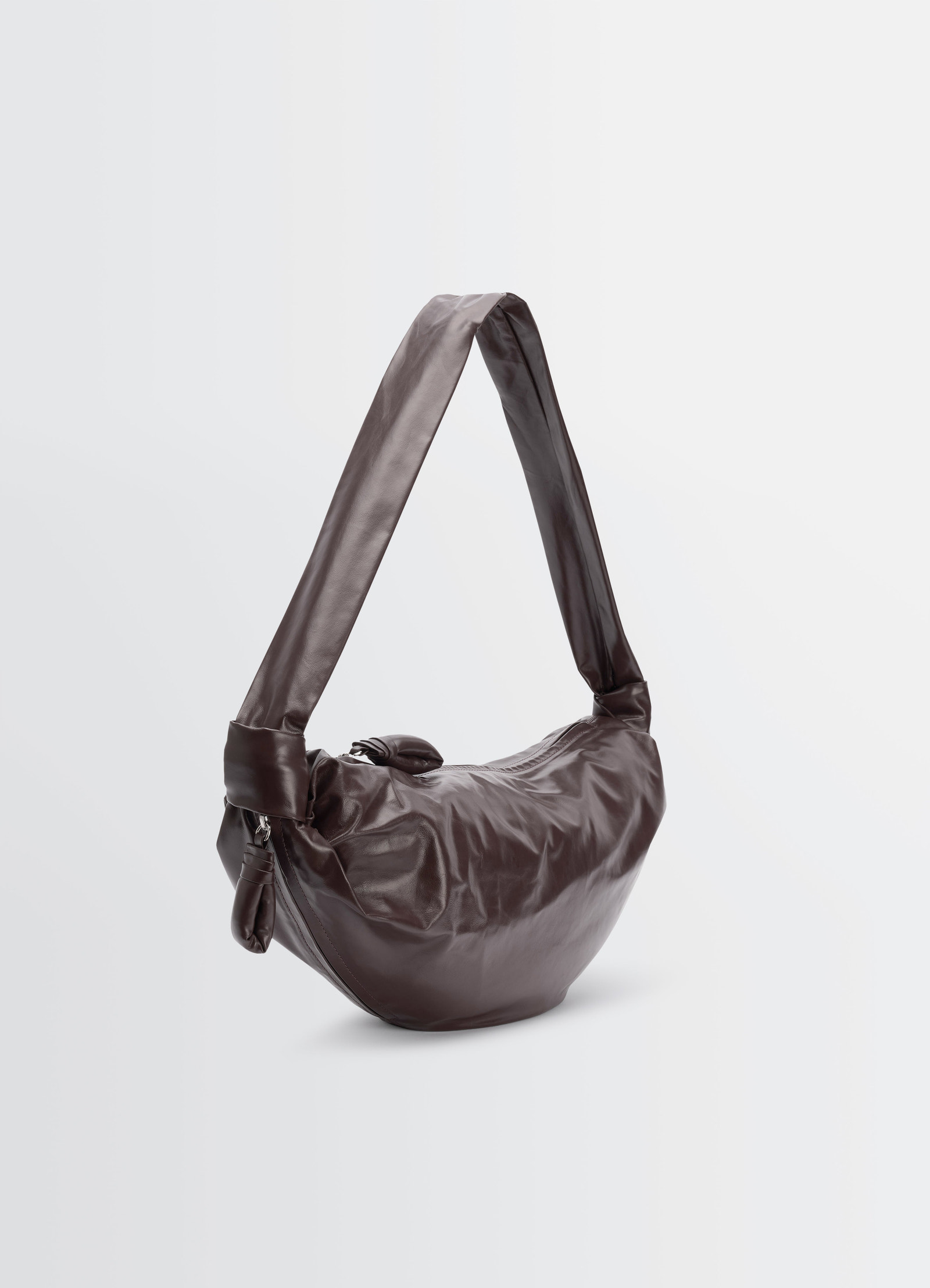 Medium soft croissant bag in dark brown paper leather by lemaire side view on plain background