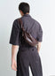 Lemaire Small Soft Croissant in Paper-effect leather, model shot, Back view Knotted strap design