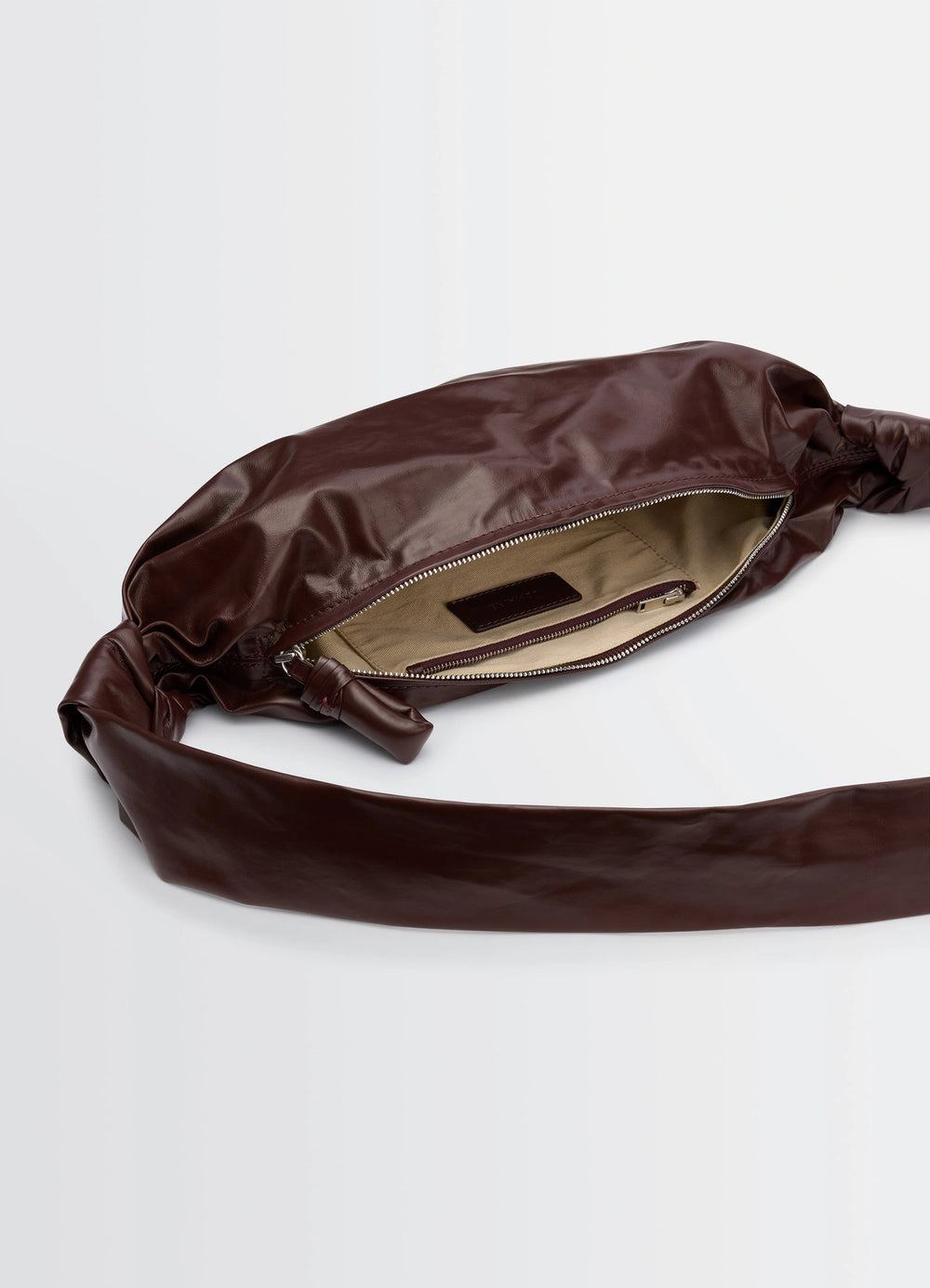 Lemaire Small Soft Croissant in Paper-effect leather, product shot, top view zippered interior detail