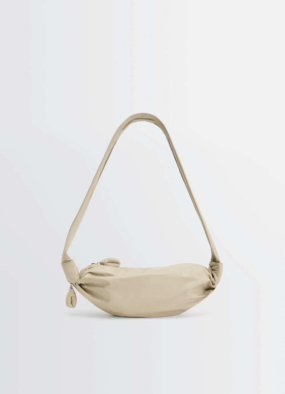 Lemaire Small Soft Croissant in Beige Paper-Effect Leather, product shot, side view curved shoulder strap