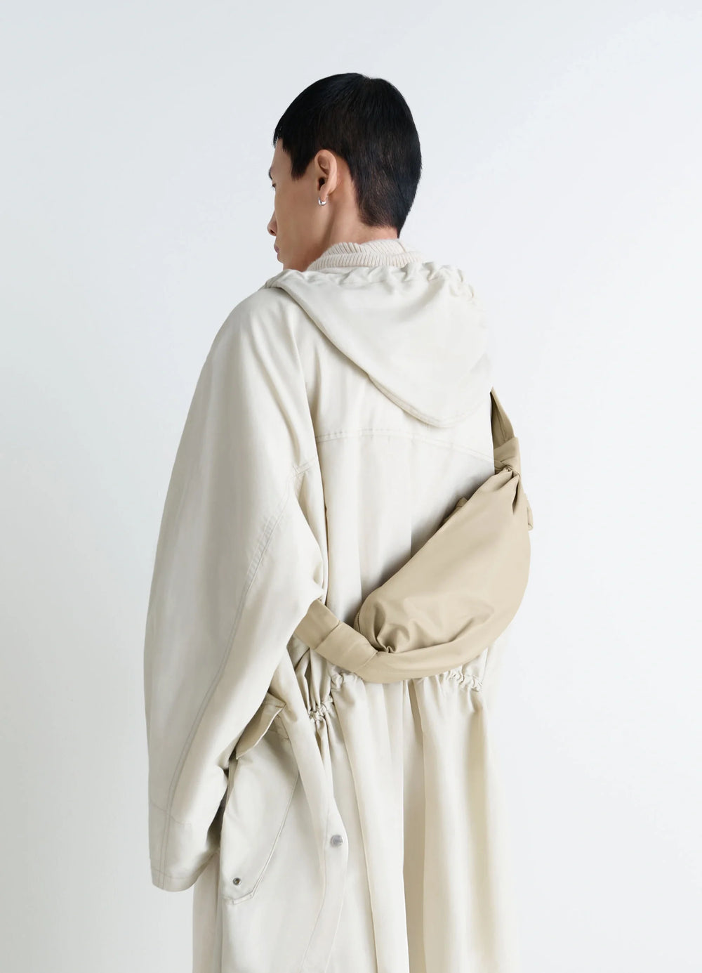 Lemaire Small Soft Croissant in Beige Paper-Effect Leather, model shot, Back view Knotted elements, draped