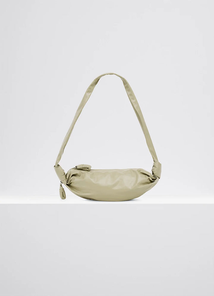 Small Soft Croissant in Lightweight Shiny Leather, product shot, side view draped with side knots