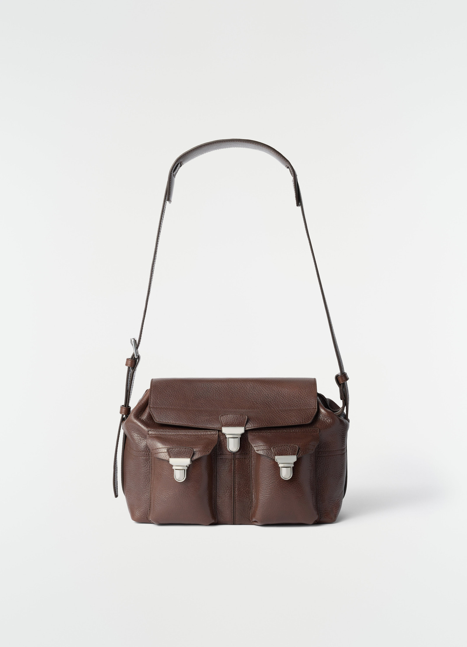 Medium brown leather gear bag with front pockets and silver clasps by lemaire on white background front view