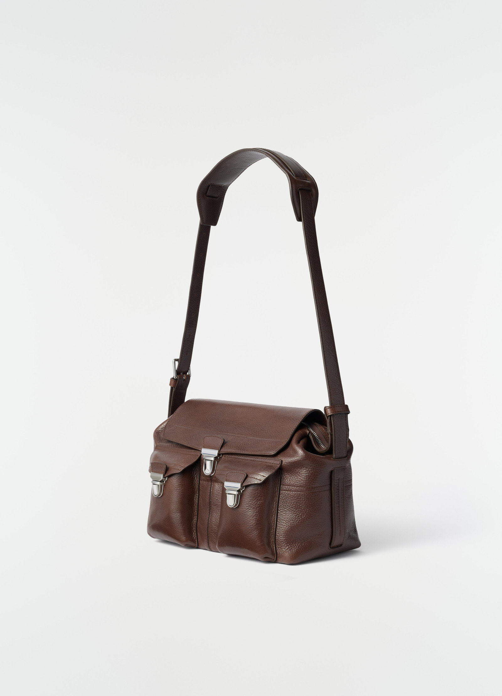 Medium brown leather gear bag with silver clasps by lemaire front side on plain white background