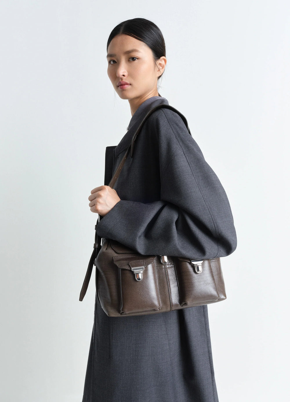 Lemaire Medium Gear Bag in Smooth Irregular Grained Leather, model shot, Side view Adjustable removable strap