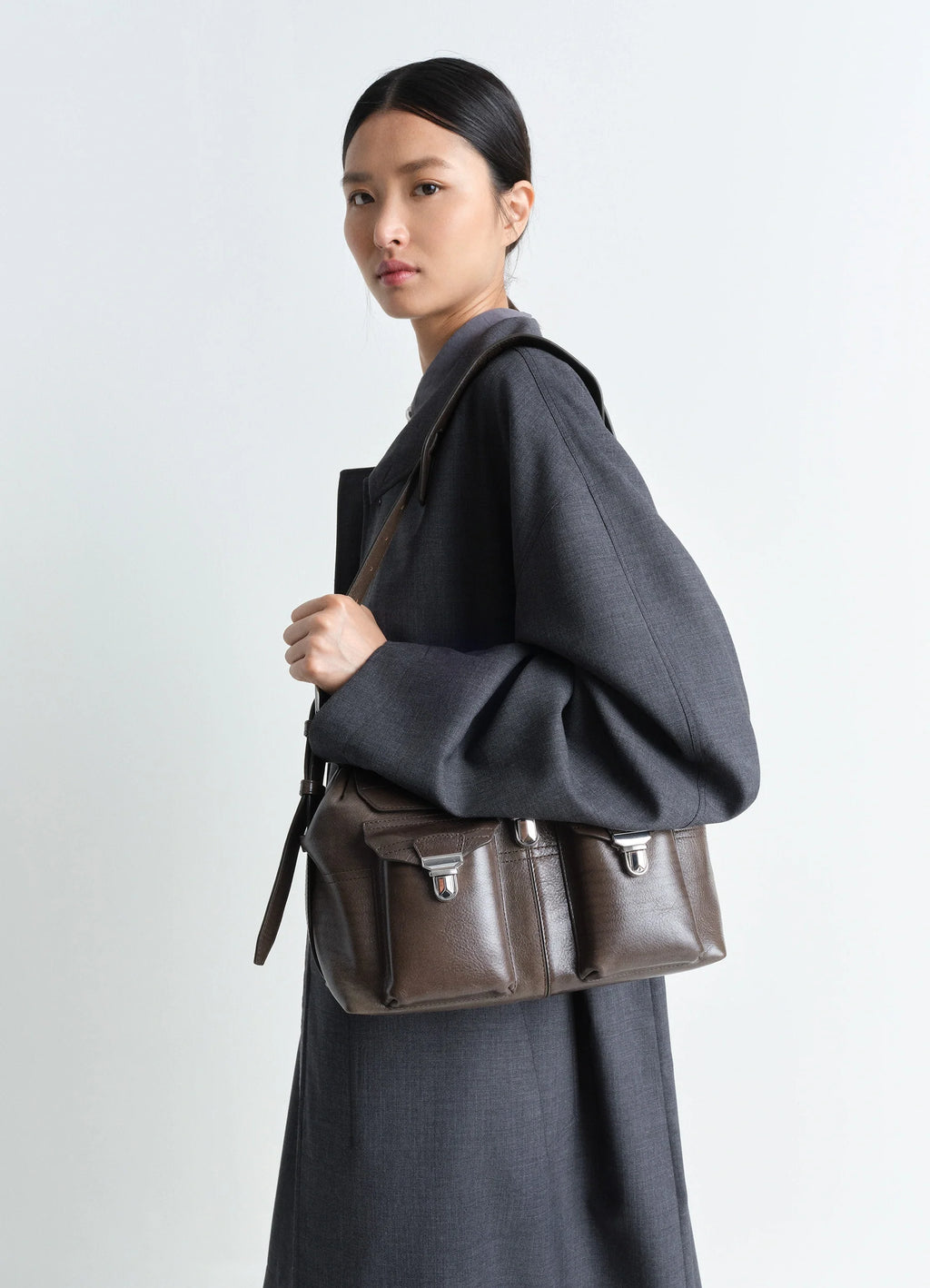 Lemaire Medium Gear Bag in Smooth Irregular Grained Leather, model shot, Side view Adjustable removable strap