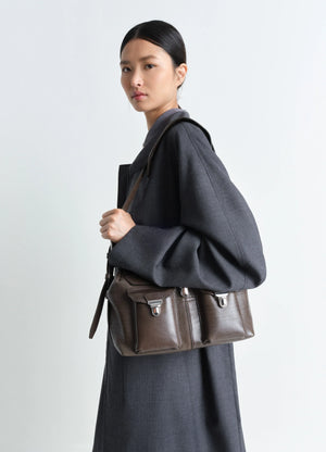 Lemaire Medium Gear Bag in Smooth Irregular Grained Leather, model shot, Side view Adjustable removable strap
