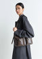 Lemaire Medium Gear Bag in Smooth Irregular Grained Leather, model shot, Side view Adjustable removable strap