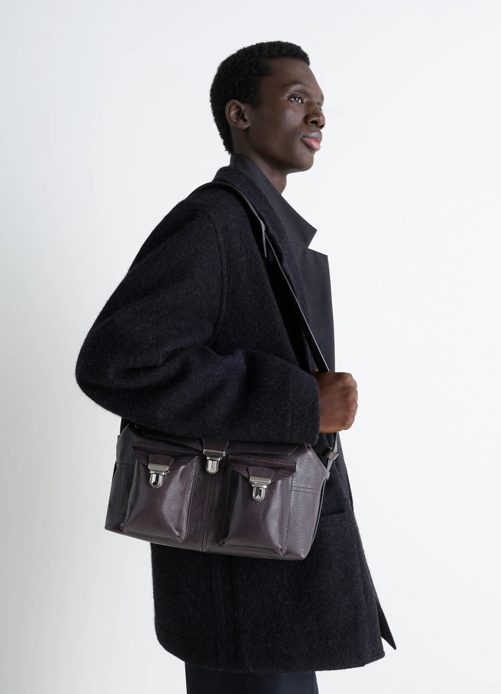 Lemaire Medium Gear Bag in Glossy Vegetable-Tanned Leather, model shot, shoulder view triple front pocket detail