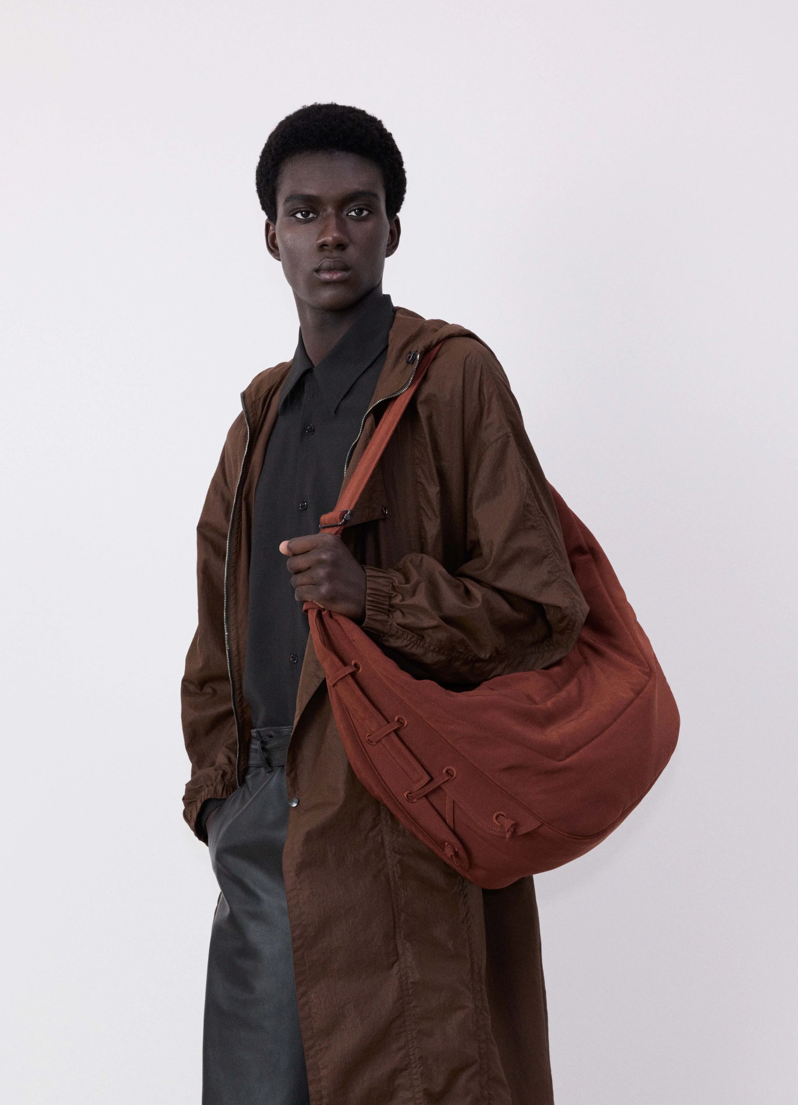 Large soft game bag in fluffy-nylon canvas, model shot, angled front view crossbody worn context
