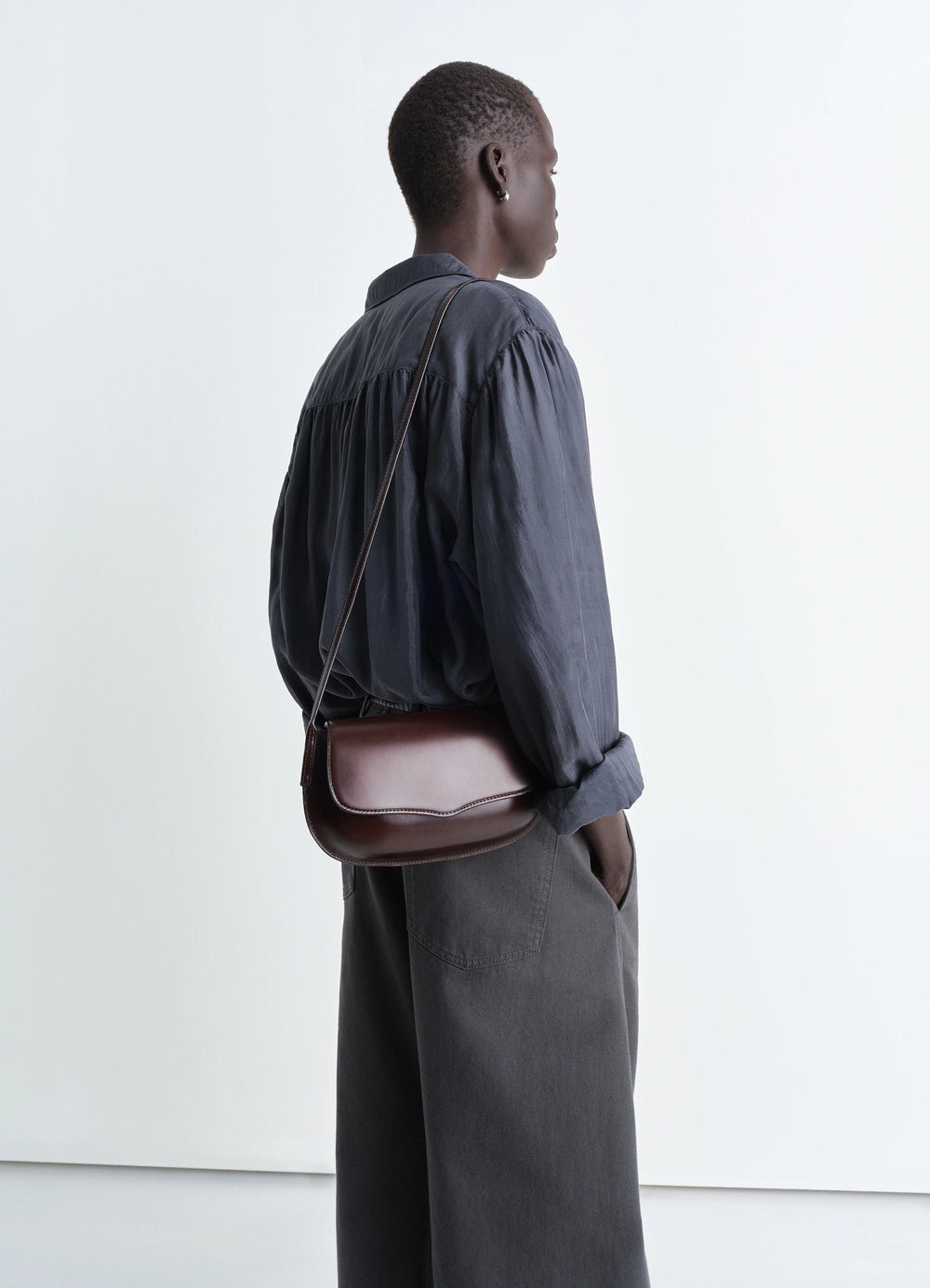 Lemaire Belly Bag in Silver LWG-certified leather, model shot, side view sculptural lightweight design
