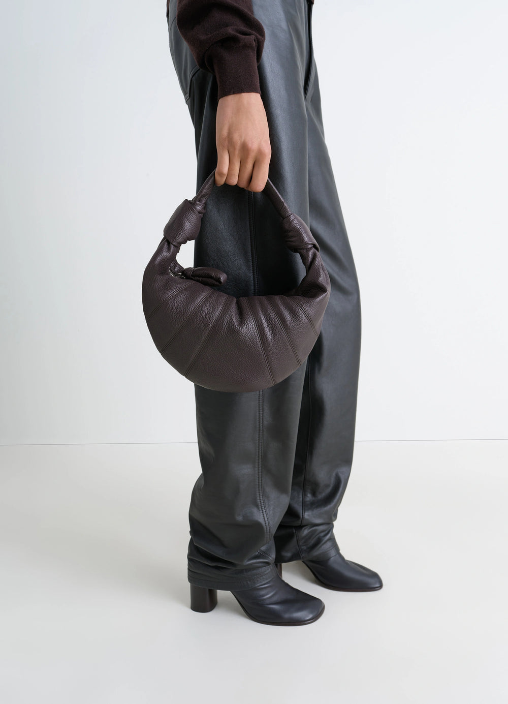 Mini Fortune Croissant Bag in Grained Leather, model shot, Side view Half-moon silhouette