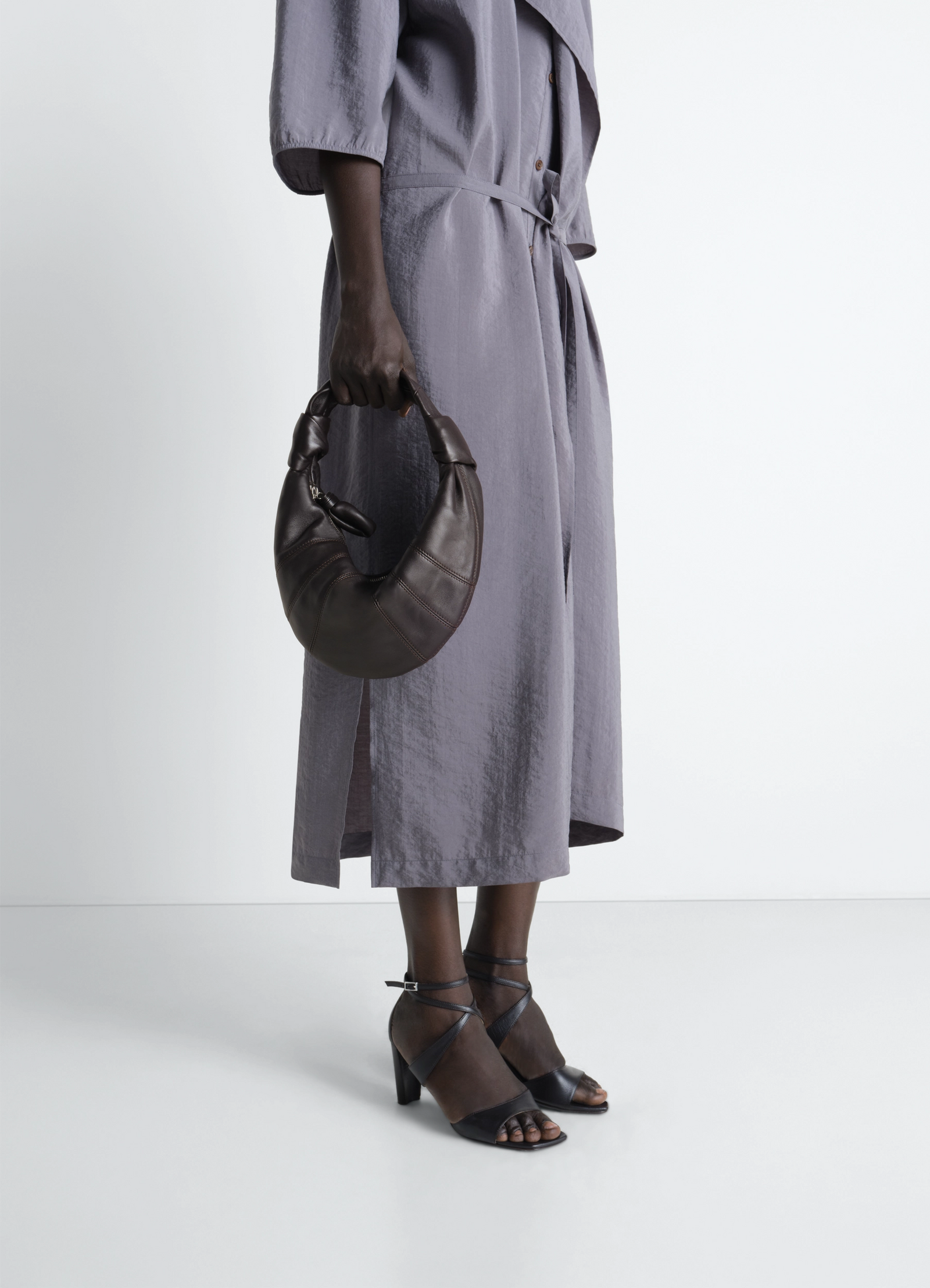 Mini fortune croissant bag in grained leather, model shot, hand-held side view crescent shape