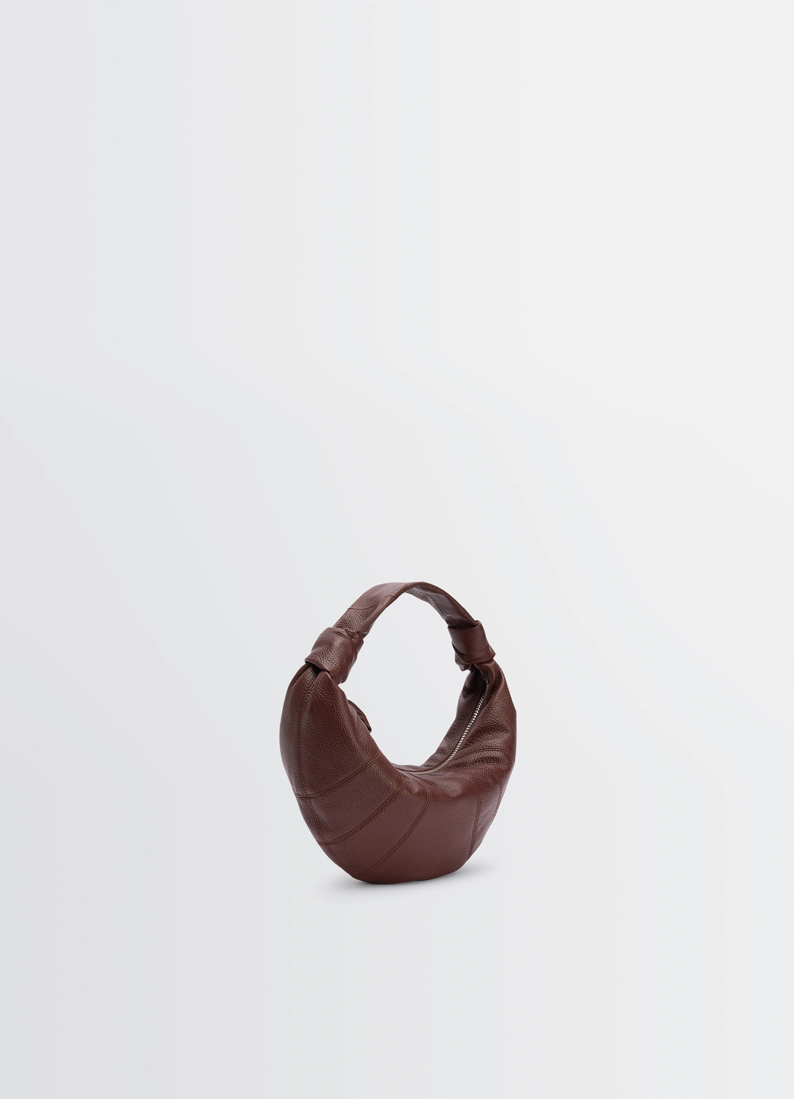 Mini fortune croissant bag in brown grained leather, product shot, three-quarter view arched top handle