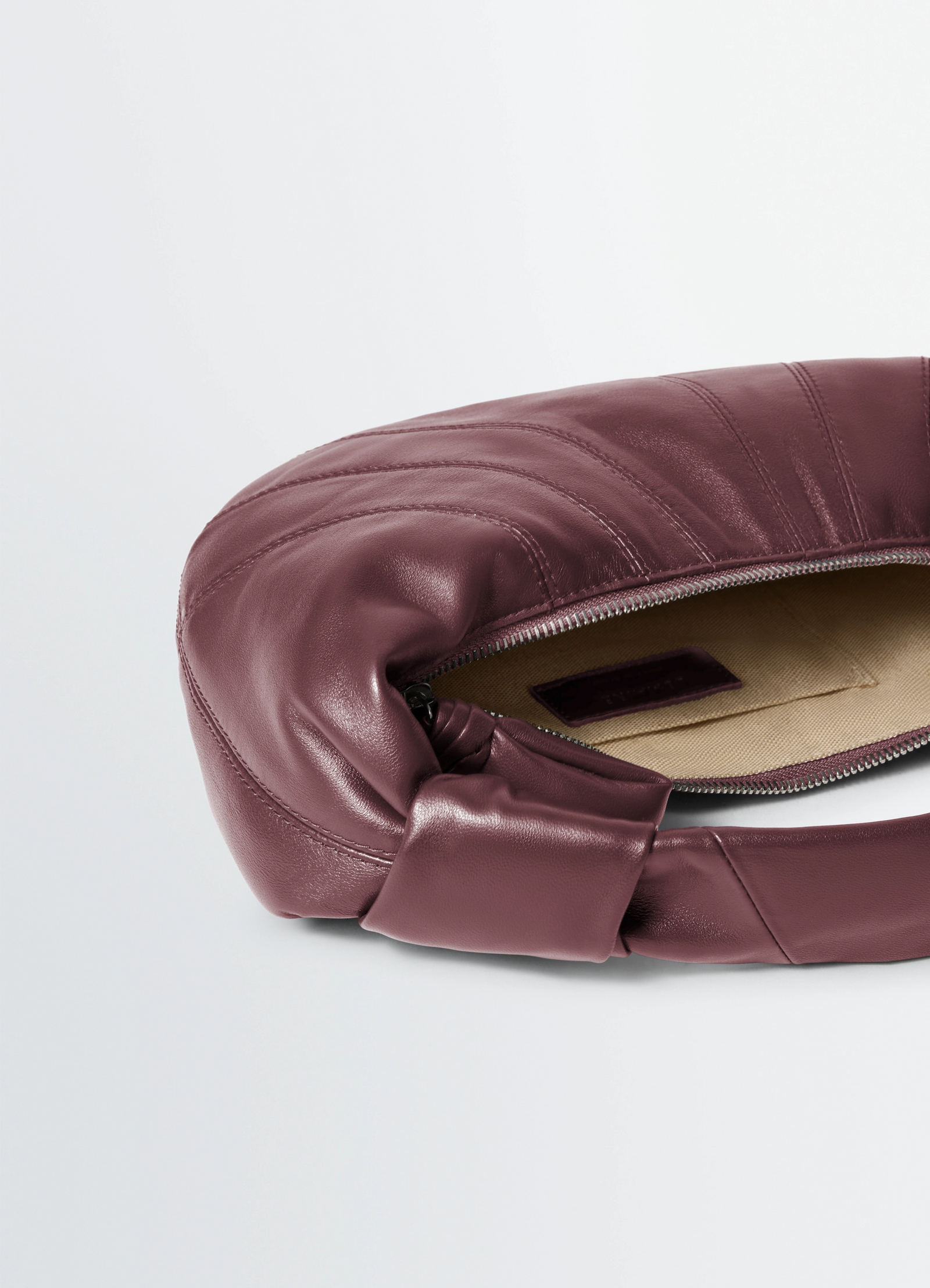 Mini fortune croissant bag in soft nappa lambskin leather, product shot, top detail shot zippered opening design