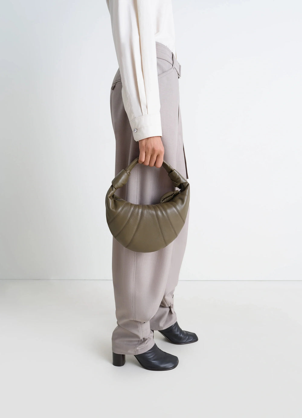 MINI FORTUNE CROISSANT BAG in Soft nappa lambskin leather, model shot, Side view Half-moon shape, knotted handle