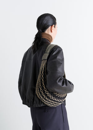 FORTUNE CROISSANT FILT BAG in nylon net with removable bag, model shot, back view shoulder carry view