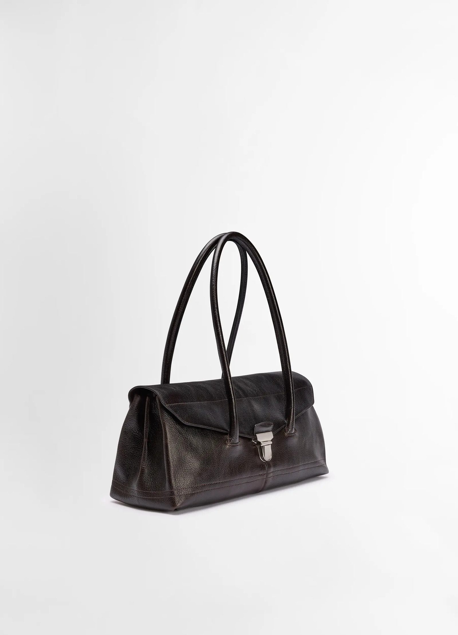 Lemaire shoulder gear bag in dark brown vegetable-tanned leather, product shot, three-quarter view elongated twin handles