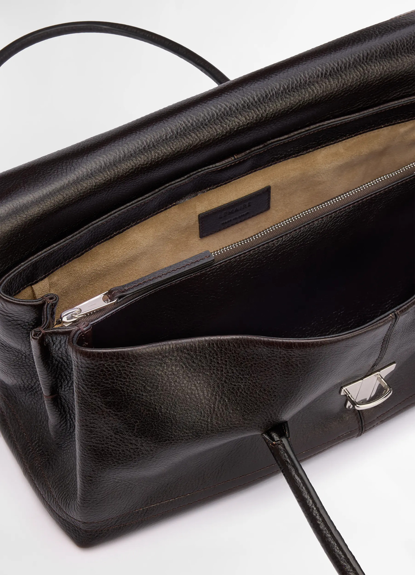 Lemaire shoulder gear bag in dark brown vegetable-tanned leather, product shot, top interior view interior zippered pocket