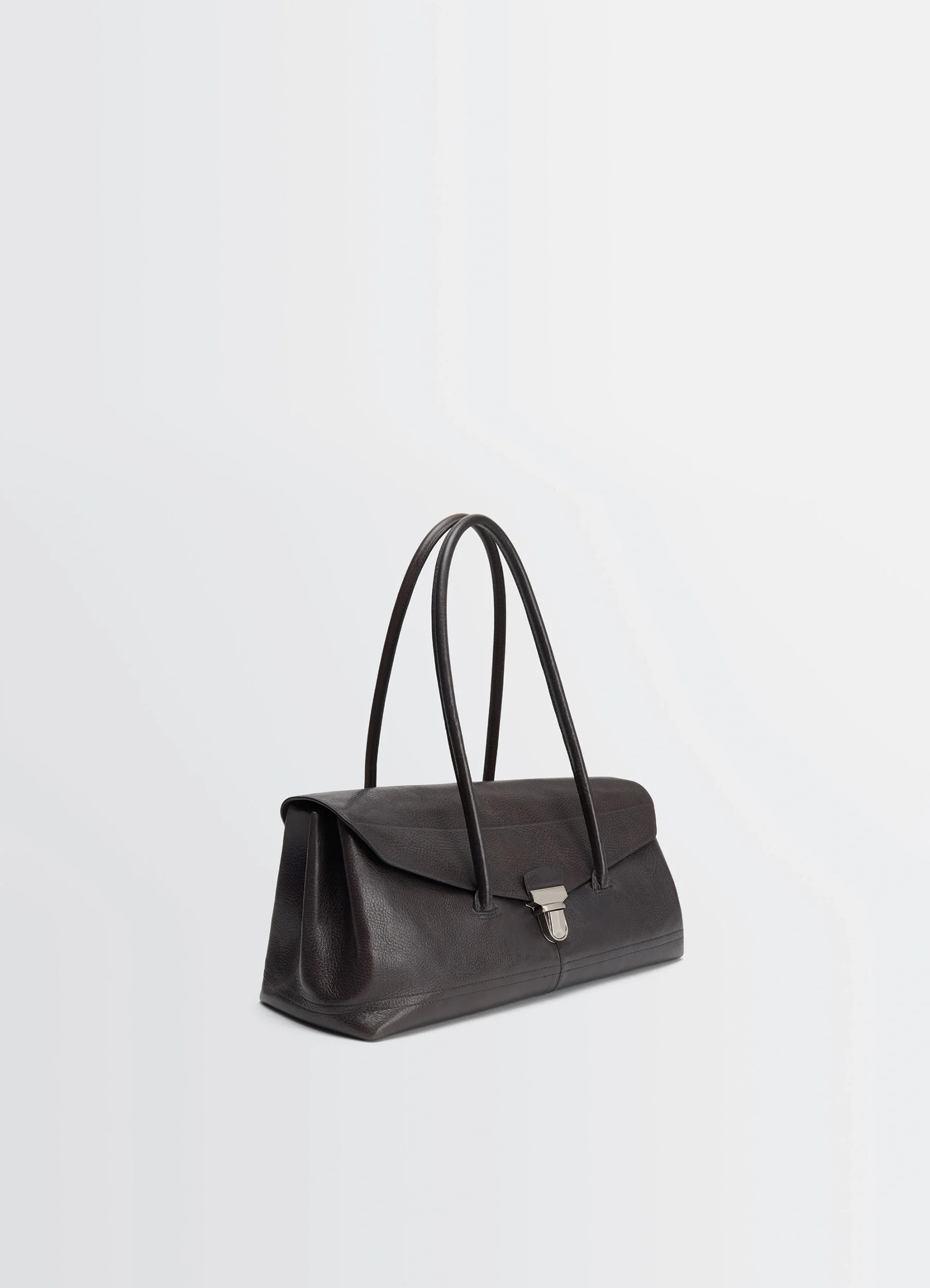 Lemaire shoulder gear bag in glossy vegetable-tanned leather, product shot, three-quarter view visible clasp detail